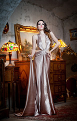 Young beautiful luxurious woman in long elegant dress. Beautiful