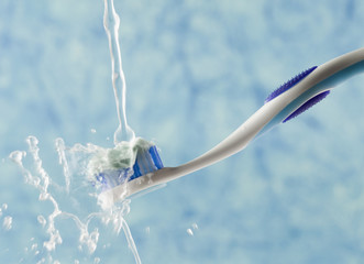 Water being poured on a toothbrush
