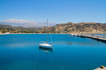 Small sailing boat anchored at a small harbour south of Crete