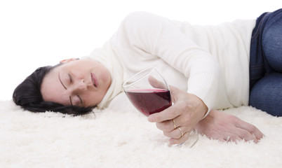 drunk woman spilling red wine on white carpet