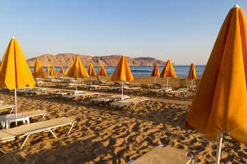 Beach sun beds and shade unbrellas.