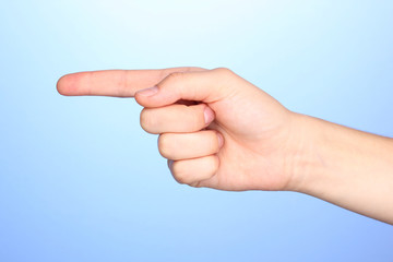 Hand making sign on blue background