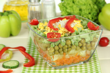 Tasty salad with fresh vegetables on wooden table