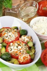 Stuffed tomatoes in bowl on wooden table close-up