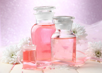 Obraz na płótnie Canvas Glass bottles with color essence, on pink background