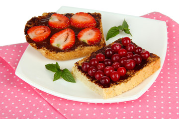 Delicious toast with berries on plate close-up