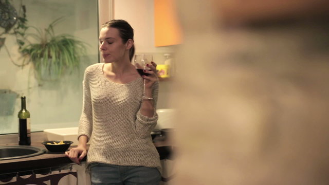 Pensive, thoughtful woman eating snacks and drinking wine