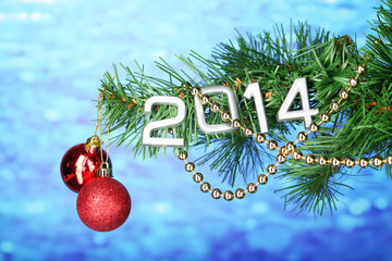 2014 hang on Christmas tree close-up on blue background