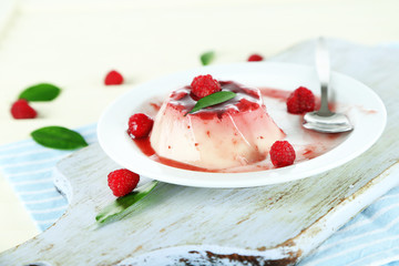 Panna Cotta with raspberry sauce, on wooden background © Africa Studio