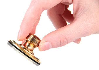 Hand with metal stamp, isolated on white