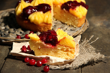 Tasty fruity homemade pie with berries, on grey wooden table
