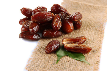 Dried dates on sackcloth isolated on white
