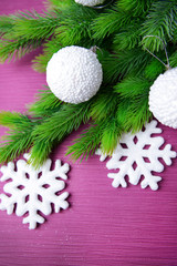 Christmas balls on fir tree, on color background