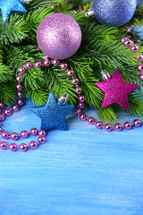 Christmas balls on fir tree, on color background