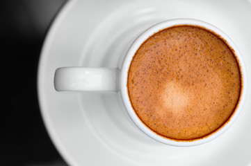 Macro close up studio shot of a cup of espresso coffee