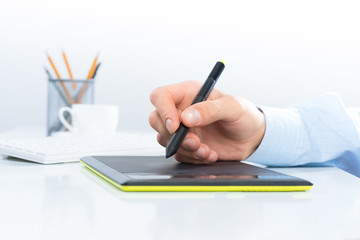 Designer hand drawing a graph on the tablet