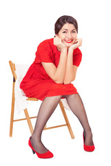 Happy woman in red dress sitting on a chair