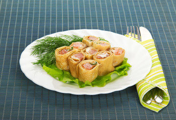 Pancakes with salmon and salad