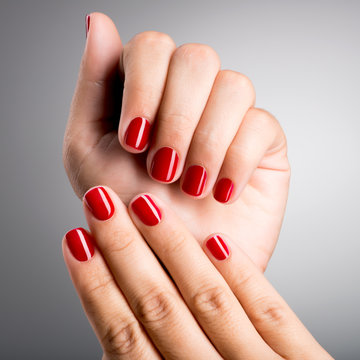 Closeup Photo Of A Female Hands With Red Nails