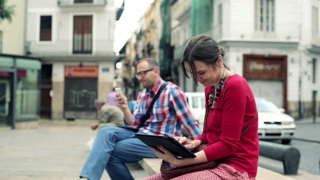 Young stylish woman with tablet computer in the city