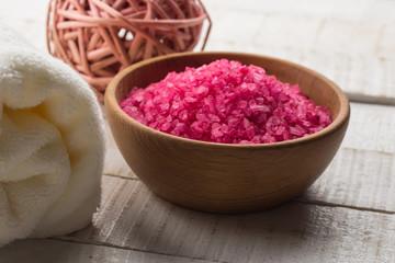 Sea salt in bowl on wooden background