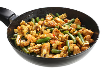 Green beans with chicken and walnuts in a frying pan