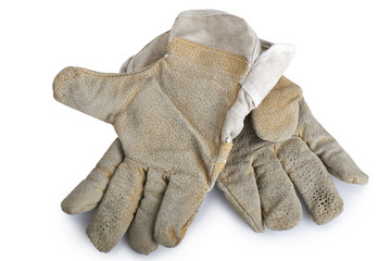 Dirty and well-worn pair of canvas and leather work gloves on wh