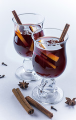 Two glasses of mulled wine on white background