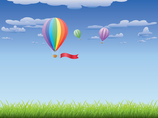 Naklejka premium Hot air balloons over grass field