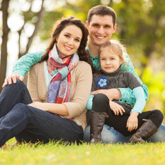 Fototapeta premium Happy mother, father and daughter in the park