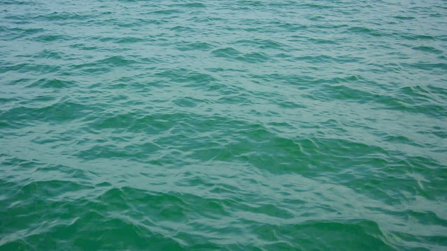 Surface of the calm ocean with small waves