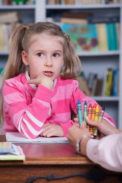 Child chooses the color pencils