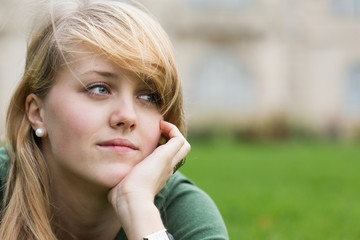 Thoughtful blonde teen girl, candid outdoor portrait
