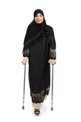 Arab woman walking with crutches