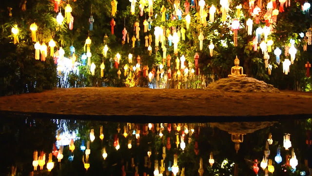 gold buddha image under beautiful lantern tree (zoom out)