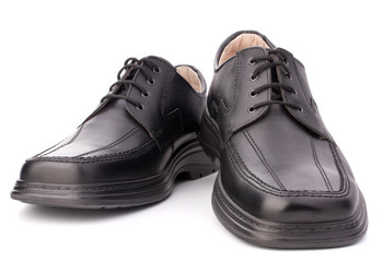 Black glossy man’s shoes with shoelaces
