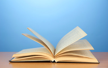 Opened book on color background