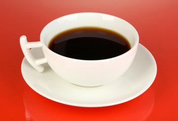 Fototapeta na wymiar A cup of strong coffee on red background