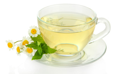 Cup of herbal tea with wild camomiles and mint, isolated