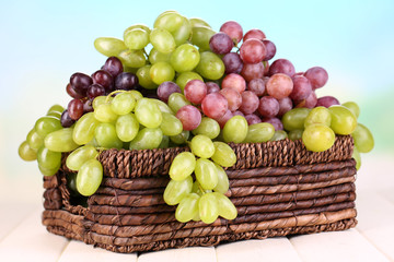 Ripe green and purple grapes in basket