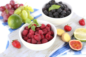 Raspberries and blackberry in small bowls