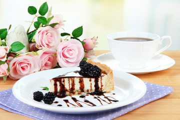 Slice of cheesecake with chocolate sauce and blackberry