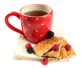 Cup of tea with cookies and berries isolated on white