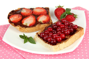 Delicious toast with berries on plate close-up
