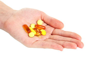 Pills in hand isolated on white