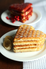 Sweet waffles on  plates. on wooden background