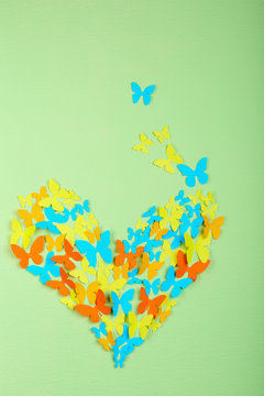 Paper butterflies on green wall