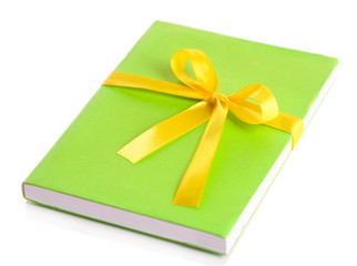 Book wrapped with color ribbon, isolated on white