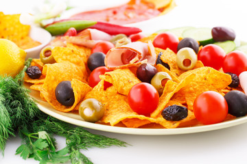 Nachos, olives, pork loin and vegetables