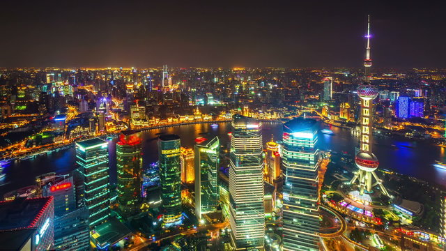 Time lapse of aerial night illuminated cityscape, Shanghai.